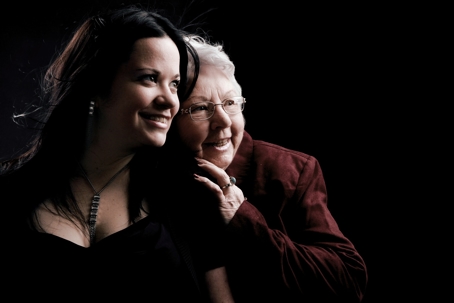 A portrait shows two women with smiles.